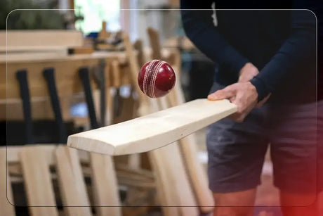 ricketer knocking-in a new bat with a red cricket ball showing cricket bat care