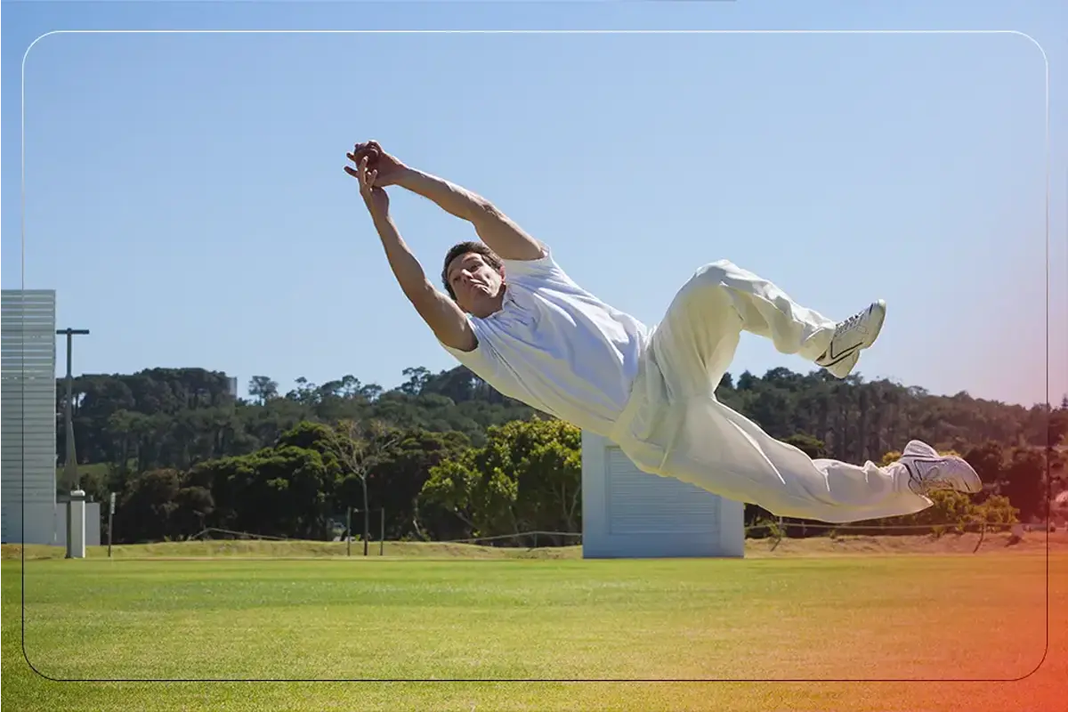 Cricket player catching a ball during practice, demonstrating techniques to improve catching skills