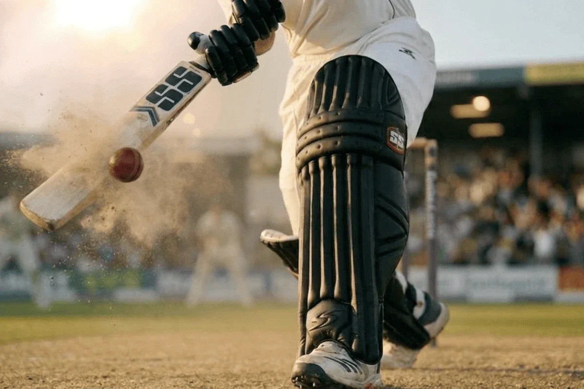 Close-up of a cricketer wearing SS batting pads while playing a front-foot shot