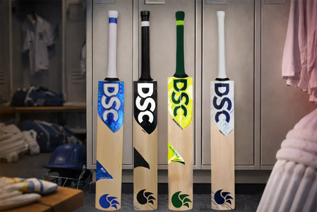 Top 4 DSC English willow cricket bats displayed upright in a locker room, showing different colorful DSC designs and grips for 2026
