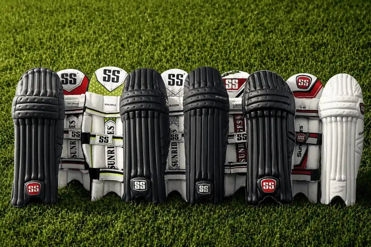 Top 5 SS batting pads in 2026 for junior and professional cricketers displayed on a grass cricket field