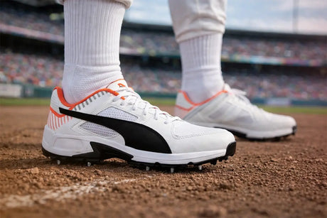 PUMA cricket shoes worn by a player on a cricket field, featuring lightweight design, rubber spikes, and enhanced grip for modern cricketers